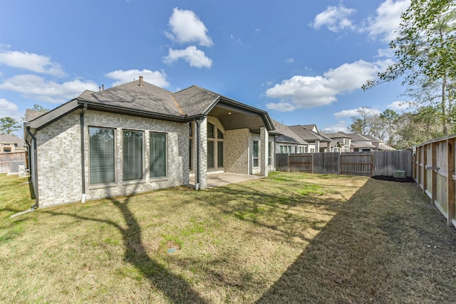 back of property featuring a yard and a patio area