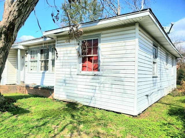 view of property exterior with a yard