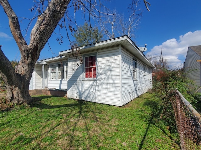 view of side of home featuring a yard