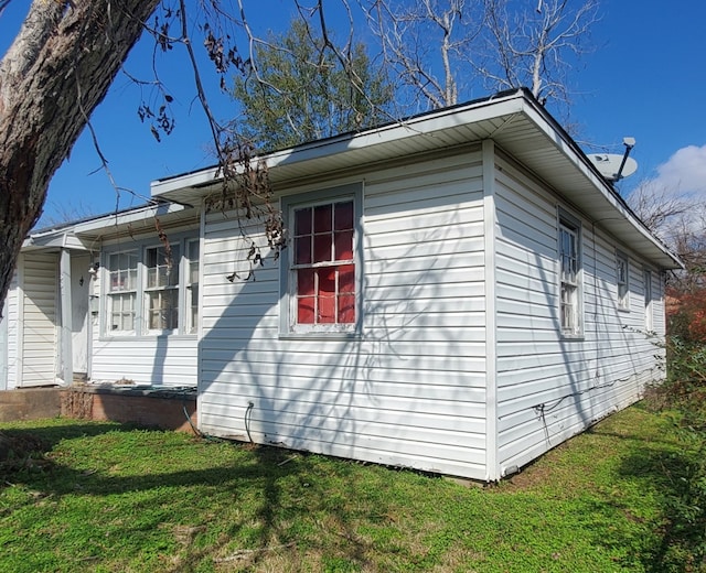 view of side of home featuring a yard