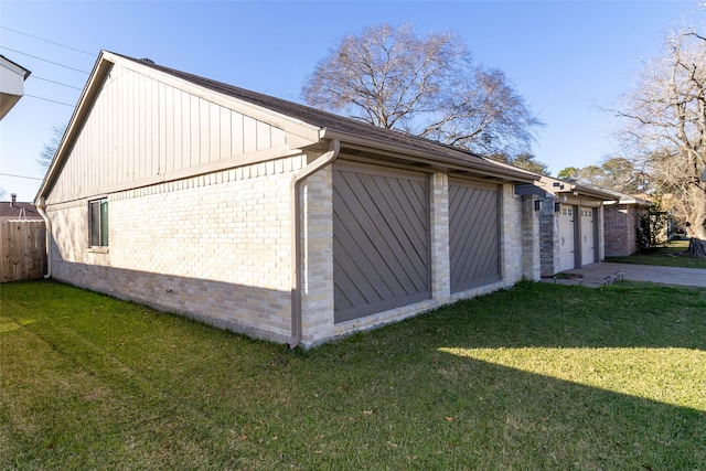 view of property exterior featuring a garage and a lawn