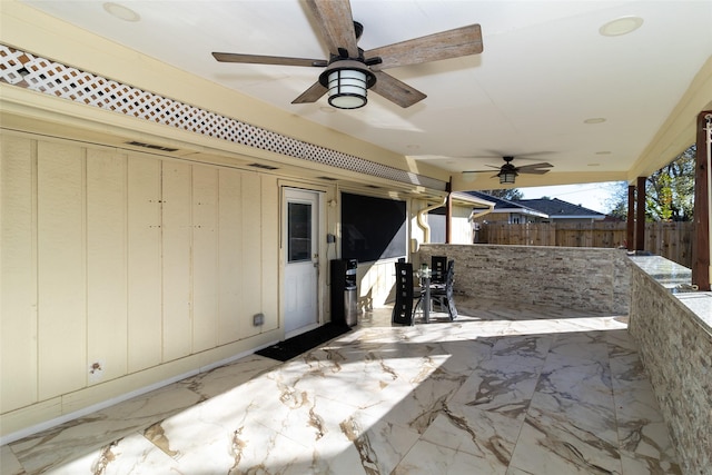 view of patio / terrace featuring fence, visible vents, and ceiling fan