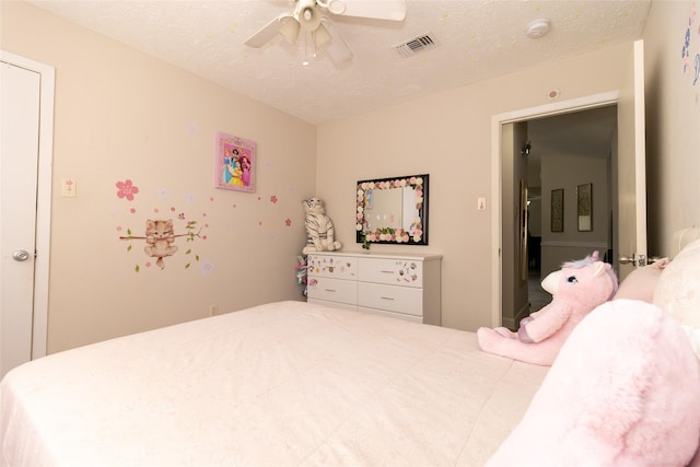 bedroom with visible vents, a textured ceiling, and ceiling fan