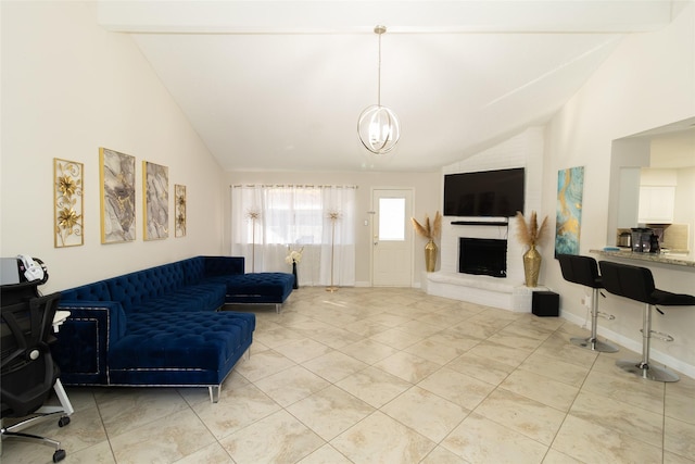 living room featuring light tile patterned floors, baseboards, a brick fireplace, a chandelier, and vaulted ceiling