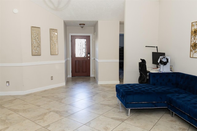 entryway featuring light tile patterned floors and a textured ceiling