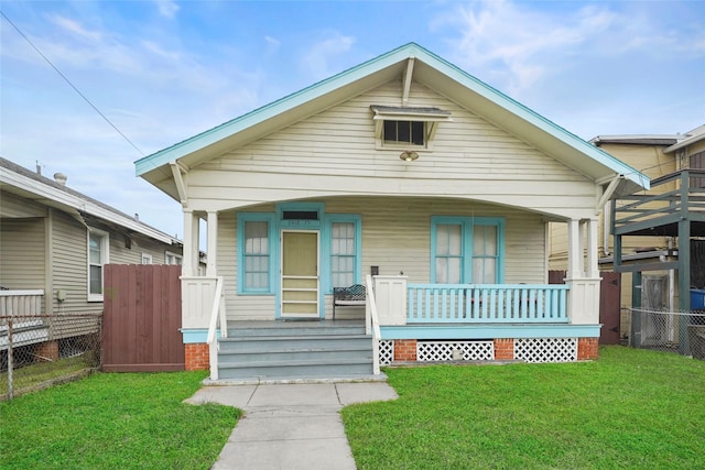 bungalow featuring a front yard and a porch