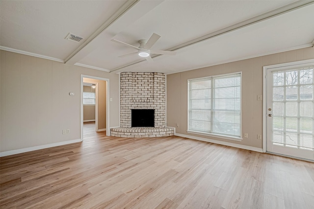 unfurnished living room with beamed ceiling, ceiling fan, a brick fireplace, and light hardwood / wood-style flooring