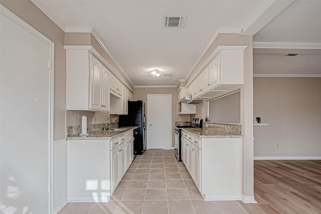 kitchen featuring light stone counters, tasteful backsplash, ornamental molding, white cabinets, and stainless steel range with gas cooktop