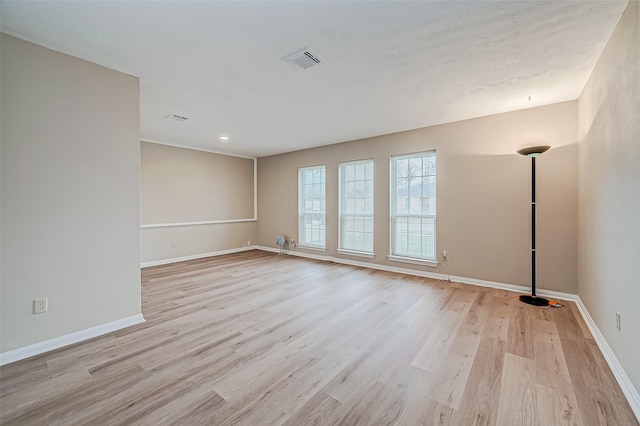 empty room with light hardwood / wood-style flooring