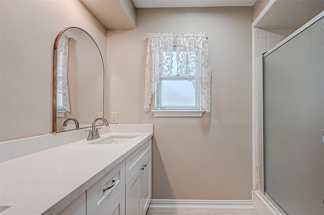 bathroom with walk in shower and vanity