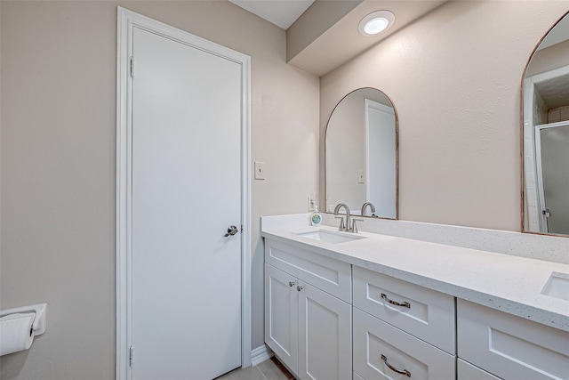 bathroom featuring walk in shower and vanity