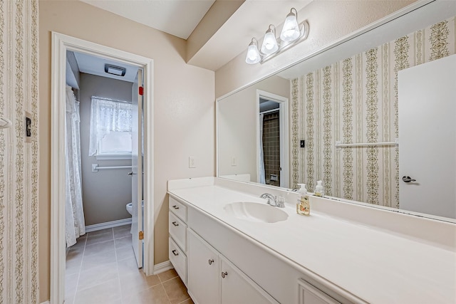 bathroom with vanity, tile patterned floors, and toilet