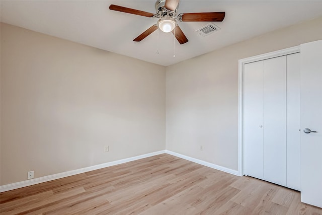 unfurnished bedroom with ceiling fan, light hardwood / wood-style floors, and a closet