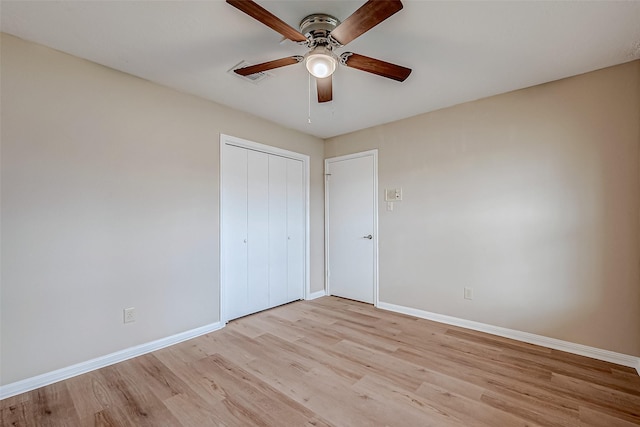 unfurnished bedroom with ceiling fan, light hardwood / wood-style floors, and a closet