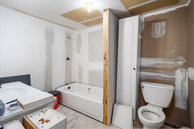 bathroom with vanity, a tub, and toilet