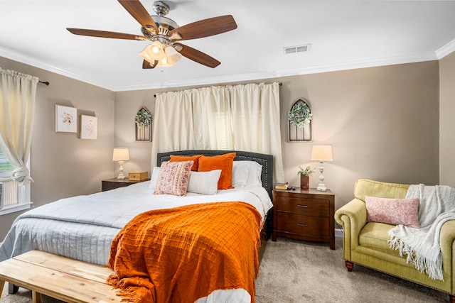 carpeted bedroom featuring crown molding and ceiling fan