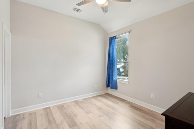 spare room featuring vaulted ceiling, ceiling fan, and light wood-type flooring