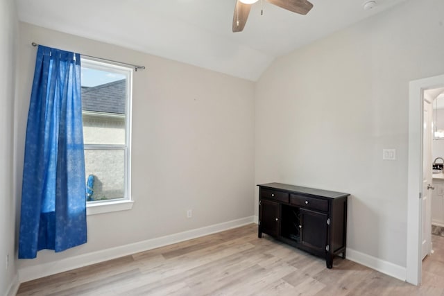 empty room with vaulted ceiling, light hardwood / wood-style floors, and ceiling fan