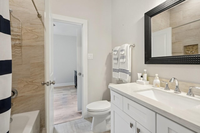 full bathroom featuring vanity, tiled shower / bath combo, and toilet