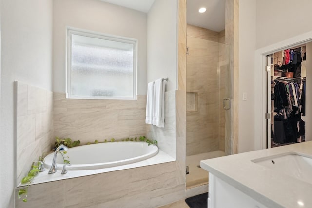 bathroom featuring vanity and separate shower and tub