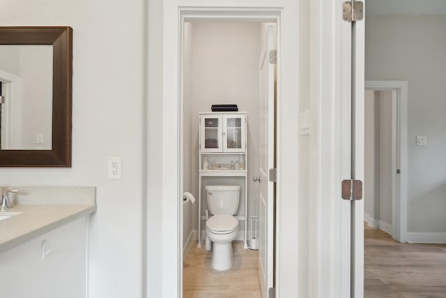 bathroom with vanity, hardwood / wood-style flooring, and toilet