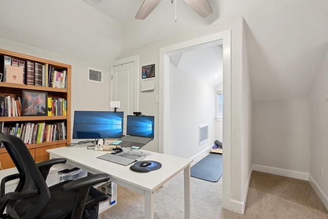 carpeted office space featuring lofted ceiling and ceiling fan