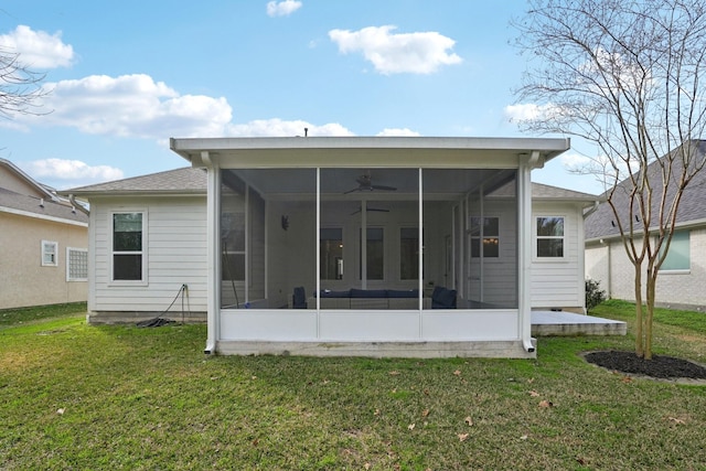 back of house with a sunroom, ceiling fan, and a lawn