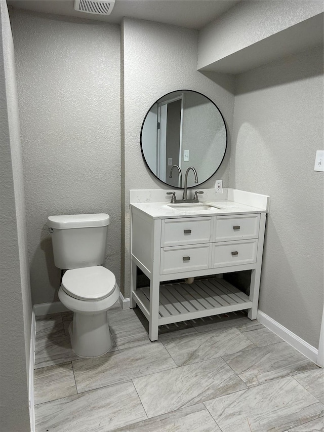 231 Dehart St Unit Cr653, Liverpool, TX 77577 - bathroom featuring toilet, baseboards, vanity, and a textured wall