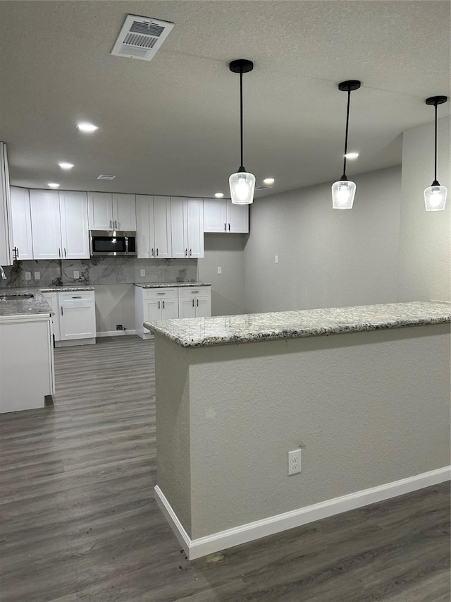 231 Dehart St Unit Cr653, Liverpool, TX 77577 - kitchen featuring stainless steel microwave, a sink, dark wood-type flooring, baseboards, and recessed lighting