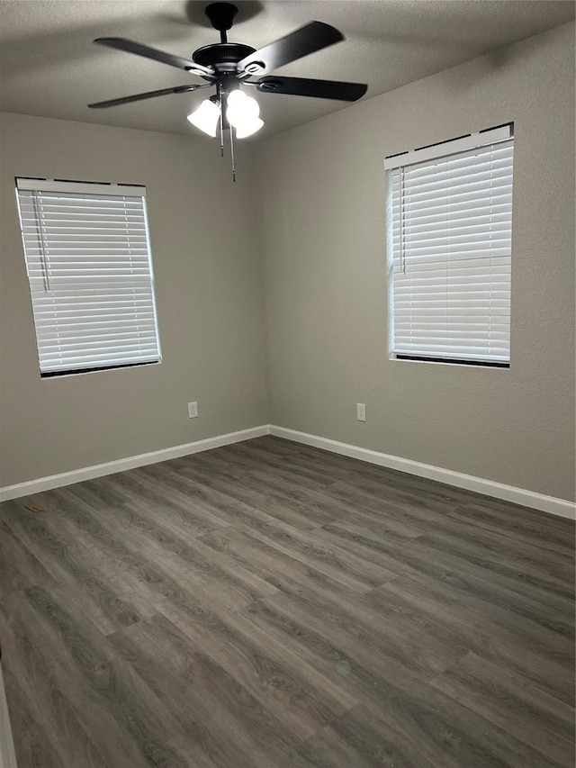 unfurnished room with ceiling fan, a textured ceiling, and dark hardwood / wood-style flooring