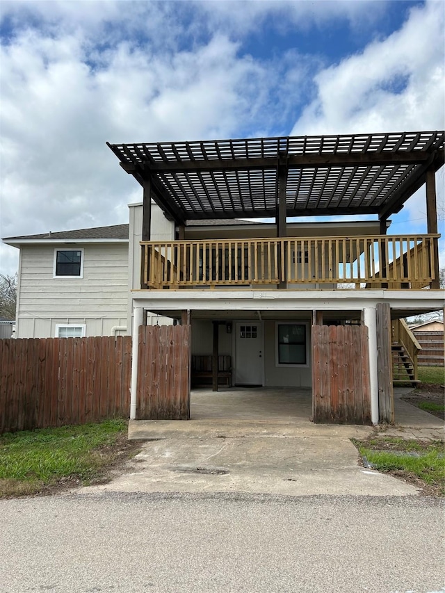 231 Dehart St Unit Cr653, Liverpool, TX 77577 - view of front facade with fence, stairs, and a pergola