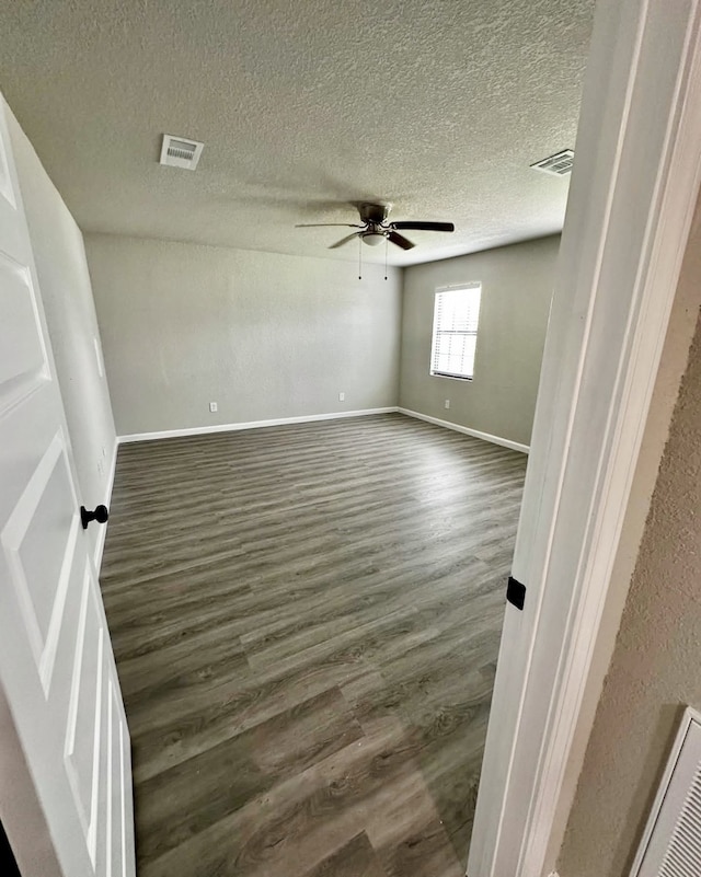 231 Dehart St Unit Cr653, Liverpool, TX 77577 - spare room with dark wood-type flooring, a ceiling fan, baseboards, and a textured ceiling