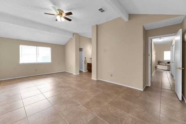 tiled empty room featuring vaulted ceiling with beams, a textured ceiling, and ceiling fan