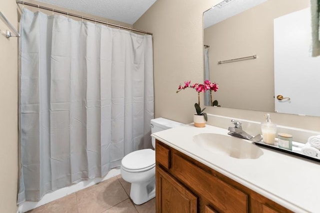 bathroom with vanity, tile patterned floors, and toilet