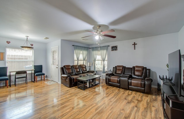 living room featuring ceiling fan and light hardwood / wood-style flooring