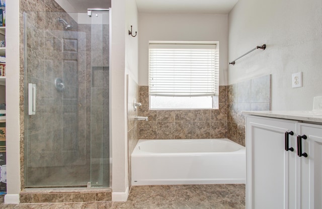 bathroom featuring vanity, tile patterned floors, and separate shower and tub