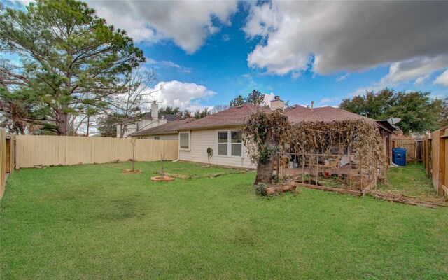 back of house featuring a yard
