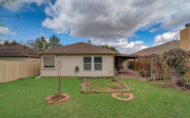 back of house with a lawn and a patio area