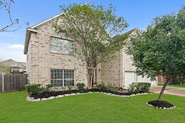 view of front of home with a garage and a front yard