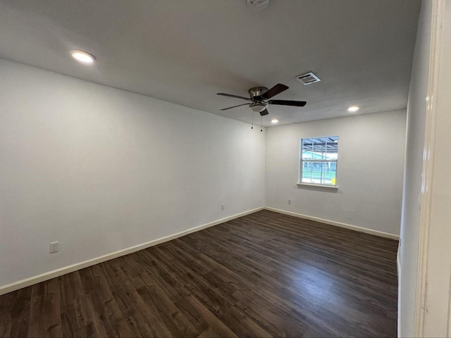 empty room featuring dark wood-type flooring and ceiling fan