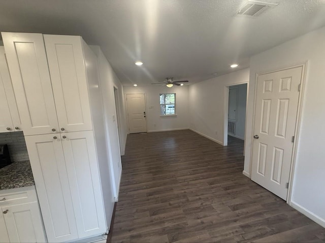 hallway with dark hardwood / wood-style flooring