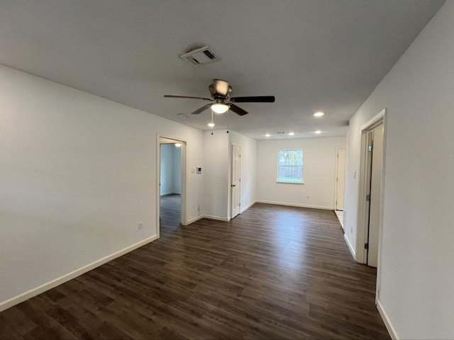 unfurnished room featuring dark wood-type flooring and ceiling fan