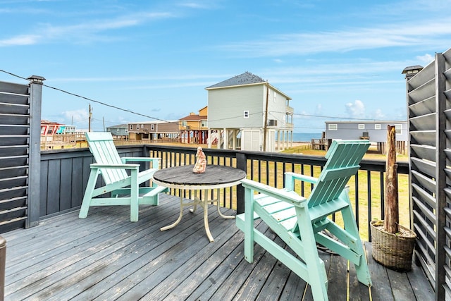 wooden terrace featuring a water view