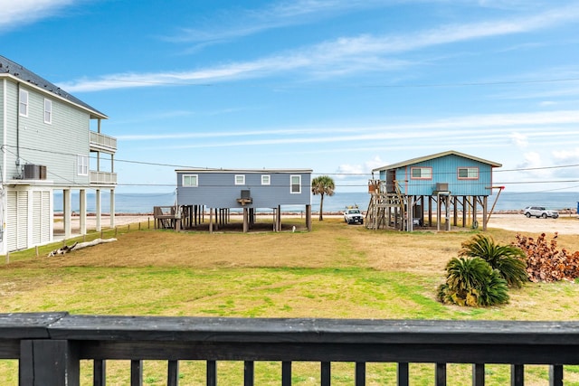 exterior space featuring central AC unit and a water view