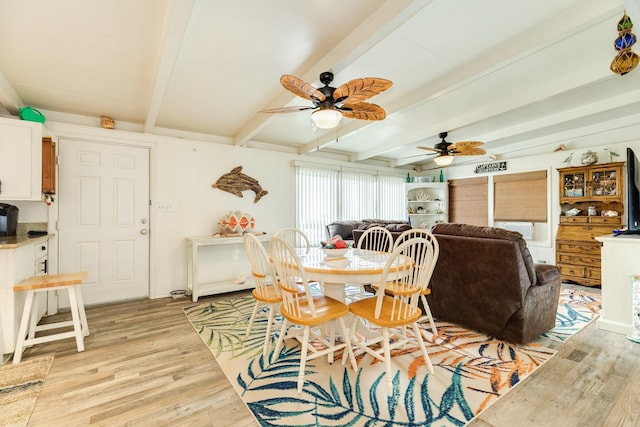 dining area with ceiling fan, light hardwood / wood-style flooring, and beamed ceiling