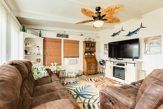 living room featuring beam ceiling, ceiling fan, and light wood-type flooring