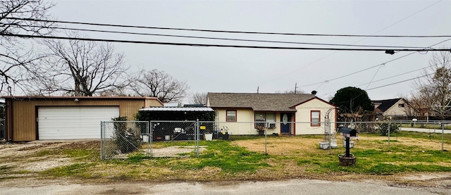 view of front facade featuring a garage and an outbuilding