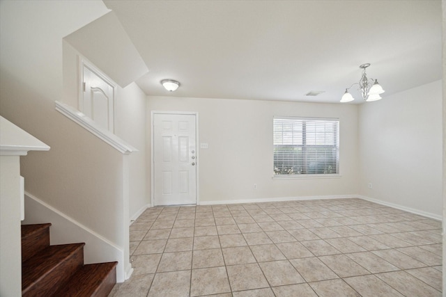 entryway featuring an inviting chandelier and light tile patterned floors