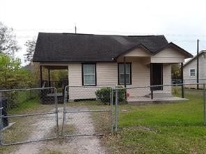 bungalow-style home with a fenced front yard and a gate