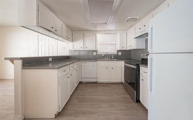 kitchen featuring sink, a textured ceiling, light hardwood / wood-style flooring, white appliances, and white cabinets